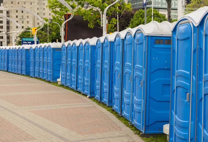 portable restrooms with sink and hand sanitizer stations, available at a festival in Carthage